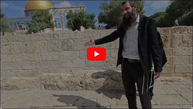 Rabbi Wolfson pointing at the bedrock